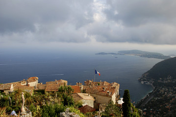 High View over rooftops and cliffs in France, Ez. French Flag on the Roofs with a view over the Mediterranean sea