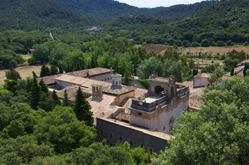 High view of a monastery roof tops midst beautiful green surroundings