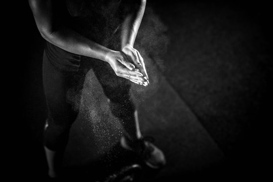 Woman Athlete Putting Weightlifting Chalk