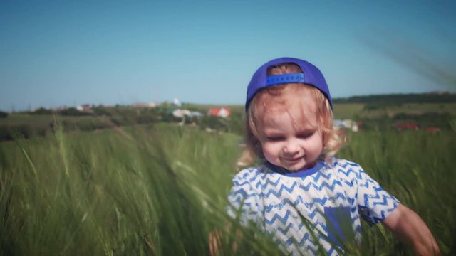 4k Happy Child Running in Wheat Fields, close-up