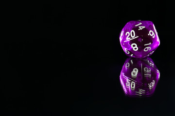 A polyhedral twenty sided die used for role playing games such as Dungeons & Dragons.