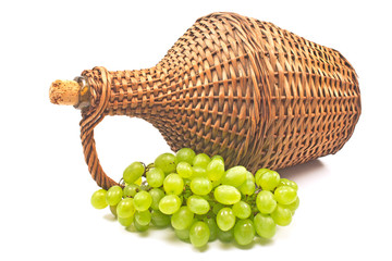 White grape with old wicker wrapped glass bottle isolated  on white background
