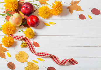 autumn leaves on white wooden background