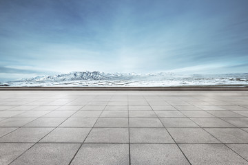 empty floor with beautiful snow mountains in blue sky