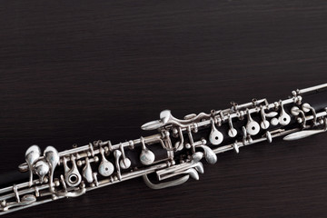 Musical background, poster - oboe on black background .  Free space for text.