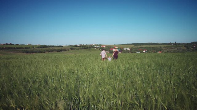 4K Family Taking Photo with Selfie Stick in Wheat Fields