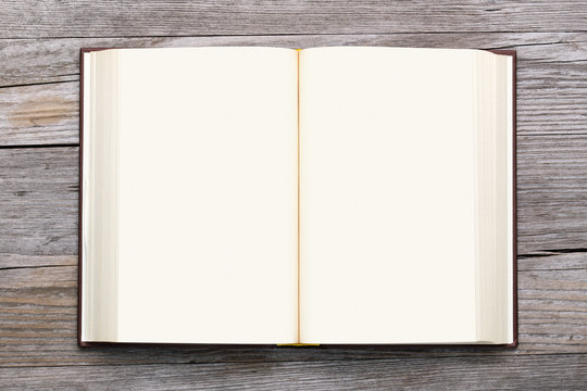 blank book open on old wooden background