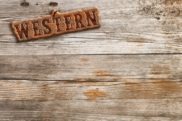 retro style western sign on aged wooden background