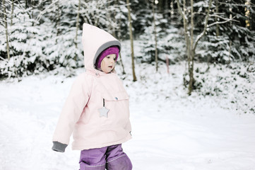Cute little girl walking in the snow