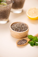 Selective focus of chia seeds drink with water in transparent glass with lemon balm.
