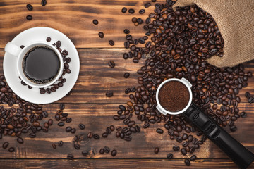 Cup of coffee espresso and beans on a rustic background