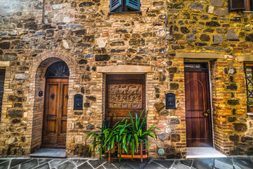 Fototapeta na wymiar Doors in a stone wall in Tuscany