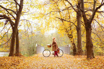 travel concept funny young woman walk with suitcase in bright autumn city park background copy space 