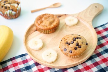 Homemade Banana cupcake on wooden plate with white background,selective focus
