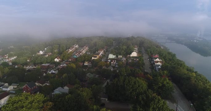 An early morning foggy aerial establishing shot of a typical Western Pennsylvania residential neighborhood. Pittsburgh suburbs.  	