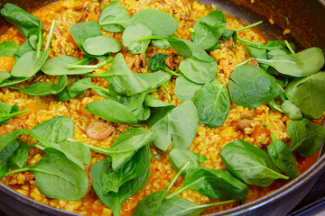 Seafood paella cooking process with squid