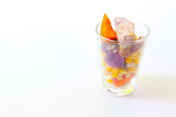 Glass of mix cereals isolated on white background.