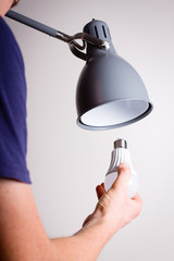 Changing the bulb for led bulb in floor lamp in gray colour.