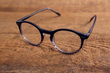 Spectacles on wooden table