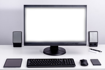 Blank white pc monitor on desktop in organized workplace.