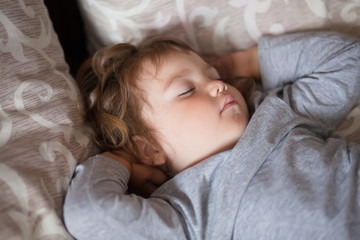 Adorable little girl sleeping in the bed