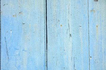 Fototapeta na wymiar Close-up Blue Peeling Paint Wooden Fence Background.