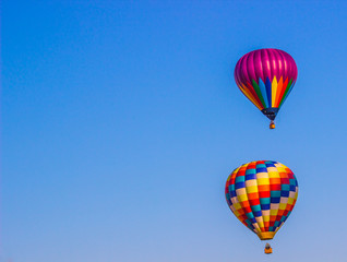 Two Multi Colored Hot Air Balloons In Early Morning
