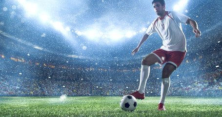 Naklejka premium Soccer player kicks the ball on the soccer stadium. He wear unbranded sports clothes. Stadium and crowd made in 3D.