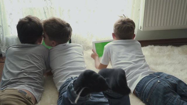 Little boys uses electronic gadgets at home