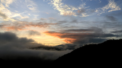mountain range tropical rainforest canopy at southern of Thailand with more cloud sunset time
