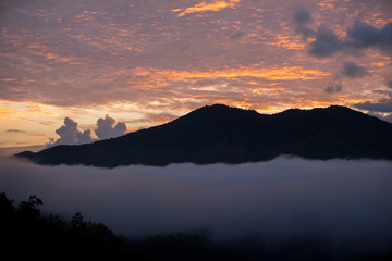 mountain range tropical rainforest canopy at southern of Thailand with more  cloud sunset time