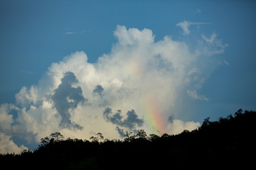 mountain range tropical rainforest canopy at southern of Thailand with more  cloud sunset time with rainbow