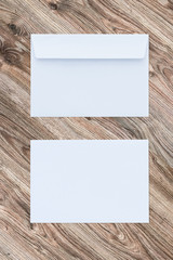 Blank white envelopes on wooden background. Two sides