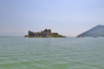 Lake Skadar in Montenegro and island Grmozur with the ruins of a fortress built by the Turks in 1843, also known as montenegrin Alcatraz. Southeast Europe.