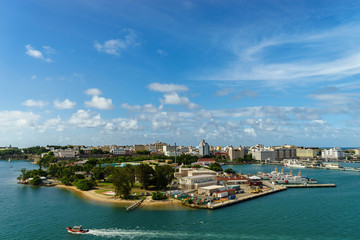 Fototapeta na wymiar Scenic view of historic colorful Puerto Rico city in distance from the sea with the port in foreground