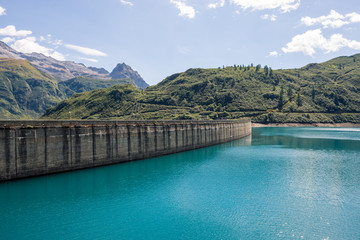Dam panorama on mountain in sunny summer day outdoor.