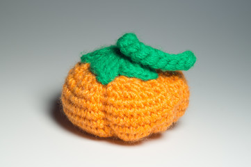 Handmade wool knitted pumpkin isolated on white