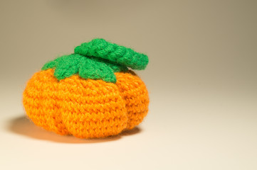 Handmade wool knitted pumpkin isolated on white
