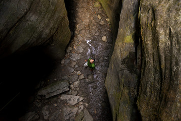 Young adult active man exploring scenic gorge in Uriezzo Italy in sunny summer day outdoor.
