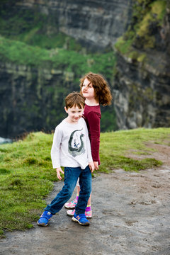 Boy and Girl walking up the Cliffs of Moher Tourist Attraction in Ireland