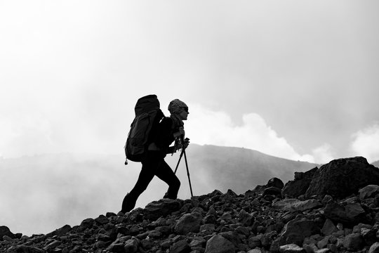 A man climbs mountains with a backpack
