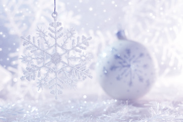 White Christmas ball on white background with snowflakes and bokeh. Christmas background .