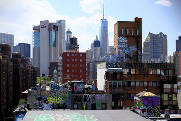 NEW YORK, USA - JUNE 2016 - View of the graffiti roofs of Chinatown and in the background the financial district