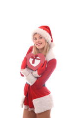 A young girl shows her happy feelimgs at Christmas time  with her present, a Christmas heart. Smilingly she stands in  front of a white background.
