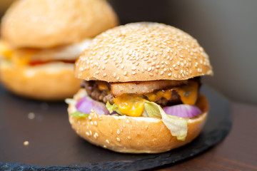 Delicious and juicy burger with salad and onion rings