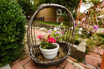 Fototapeta na wymiar decorative wicker basket, street decor, flower pot