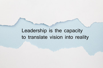 Leadership is the capacity to translate vision into reality written under torn paper