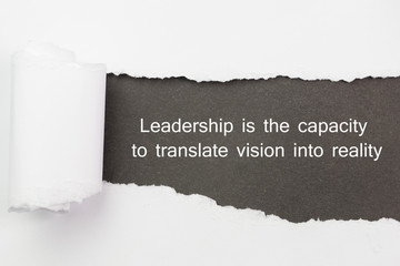 Leadership is the capacity to translate vision into reality written under torn paper