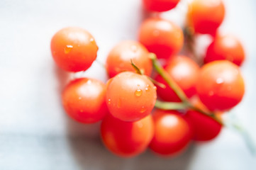 Cherry tomatoes on marble background, close up, selective focus