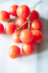 Cherry tomatoes on marble background, close up, selective focus
